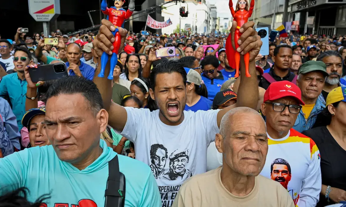 A demonstrator holds action figures of 