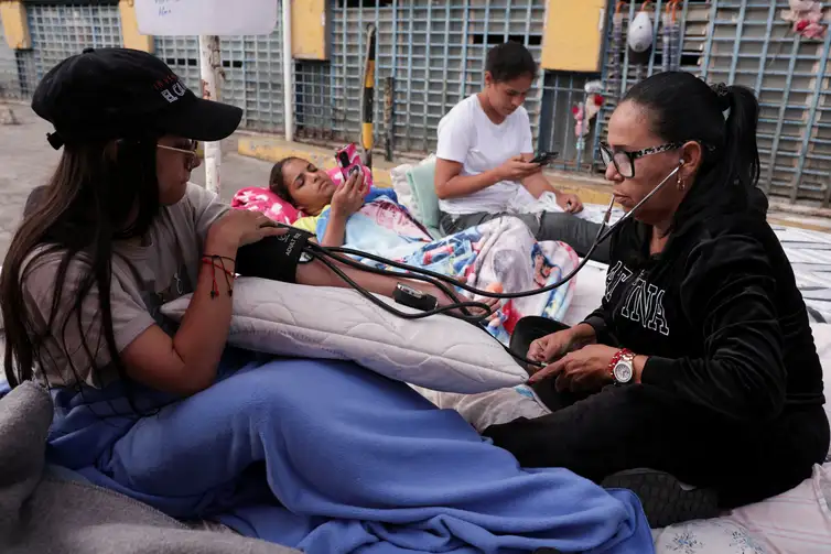 Relatives of detainees go through medical checkups as they enter their third day of a hunger strike after the National Assembly of Venezuela postponed debate on an amnesty bill, outside the National Police Zone 7 detention centre in Caracas, Venezuela, February 16, 2026. REUTERS/Gaby Oraa
